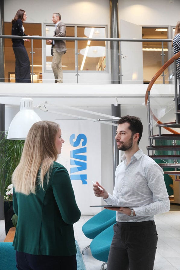 Two persons in discussion in office