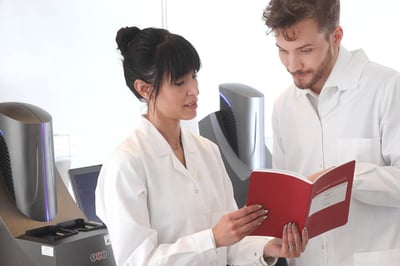 Svar-Life-Science-two-standing-laboratory-technicians-discussing-meso-scale-discovery-platform-procedures-1